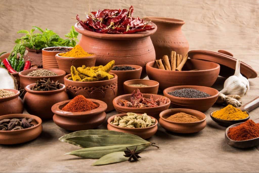 authentic indian spices in pots and bowls in a desi style, which are further used by barshala in preparing their tasty indian food in hamilton, ontario
