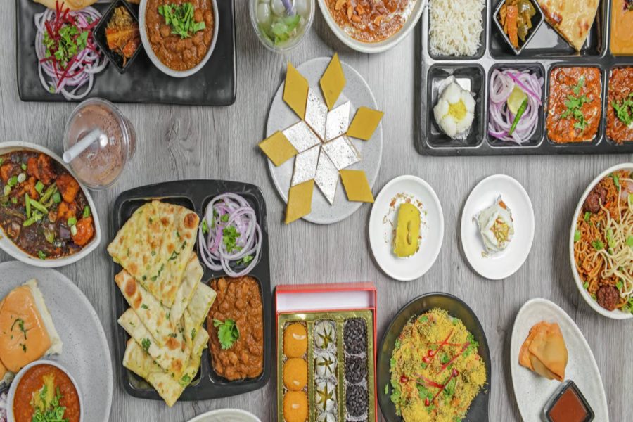 Table full of popular Indian snacks at BarShala, the top restaurant for Indian snacks in Hamilton, featuring samosas, pav bhaji, chaat, and more.